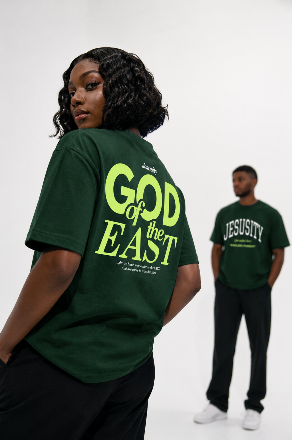 Jesusity Tee front view — varsity arc wordmark on forest green heavyweight cotton
